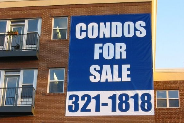 Real estate outdoor vinyl banner promoting condos for sale