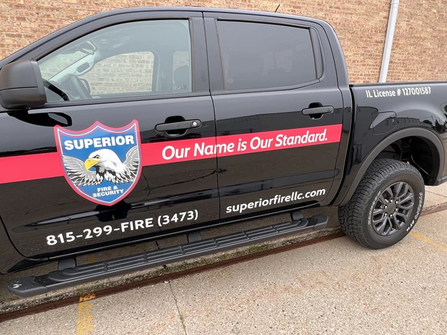 Vehicle Lettering | Professional Services Signs | Rockford, IL | Vinyl | Superior Security | Track Decals | Truck Graphics | Vinyl Graphics | Custom Graphics 